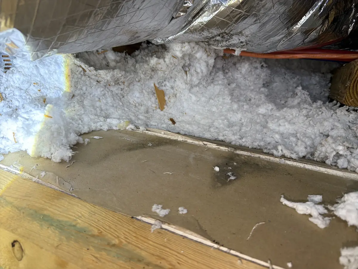 Moisture staining beneath an attic duct in a humid Florida home